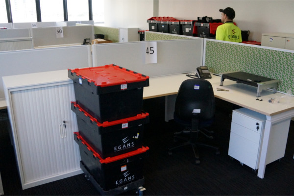 packed crates at office desk